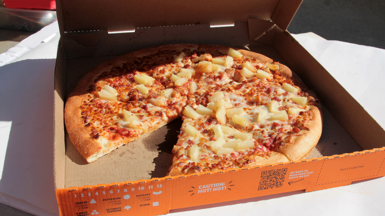 A Little Caesars pizza loaded with pineapple chunks