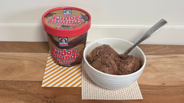 Little Debbie Fudge Rounds ice cream next to a bowl of ice cream on colored napkins and cutting board