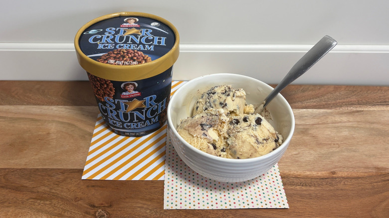 Little Debbie Star Crunch Ice Cream Pint next to a bowl of ice cream on colored napkins and cutting board