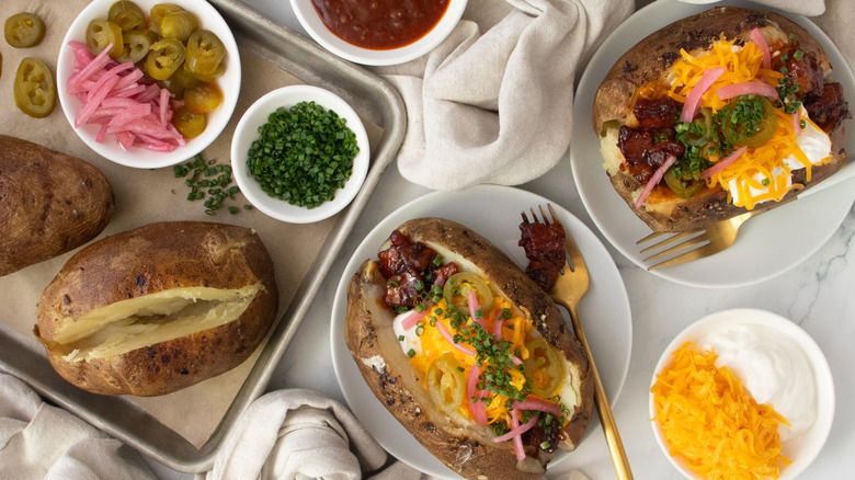 Loaded barbecue pork belly baked potatoes overhead shot
