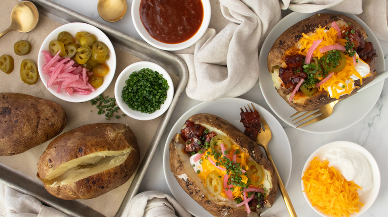 Loaded barbecue pork belly baked potatoes overhead shot