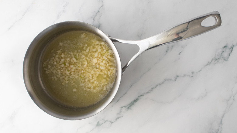 Garlic sauteed in butter in a small saucepan