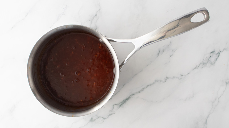 Simmering barbecue sauce in a small saucepan
