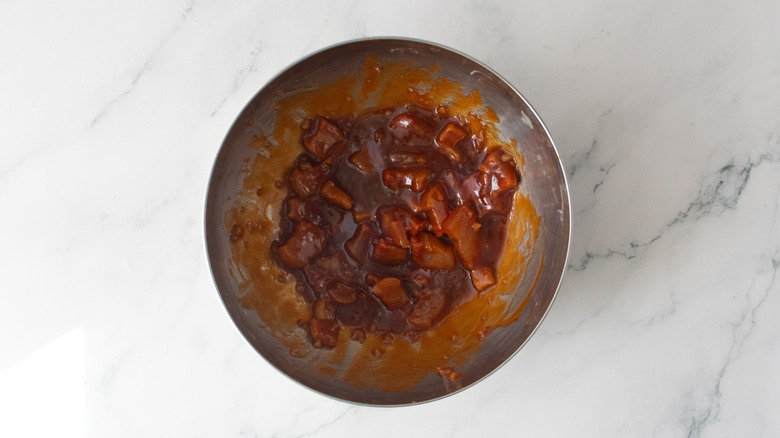 Pork belly in a bowl coated in barbecue sauce