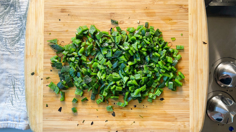 Chopped roasted poblano peppers on cutting board