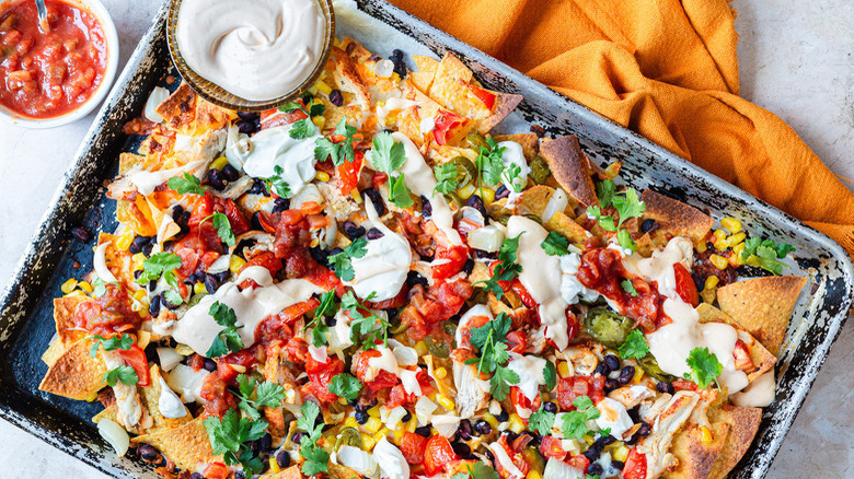 plate of chicken nachos with sour cream
