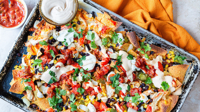 plate of chicken nachos with sour cream