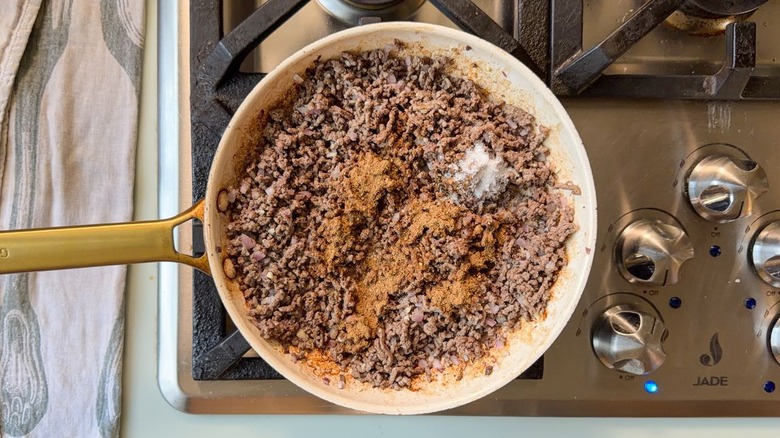 Ground beef with ras el hanout spice mix in skillet on stovetop