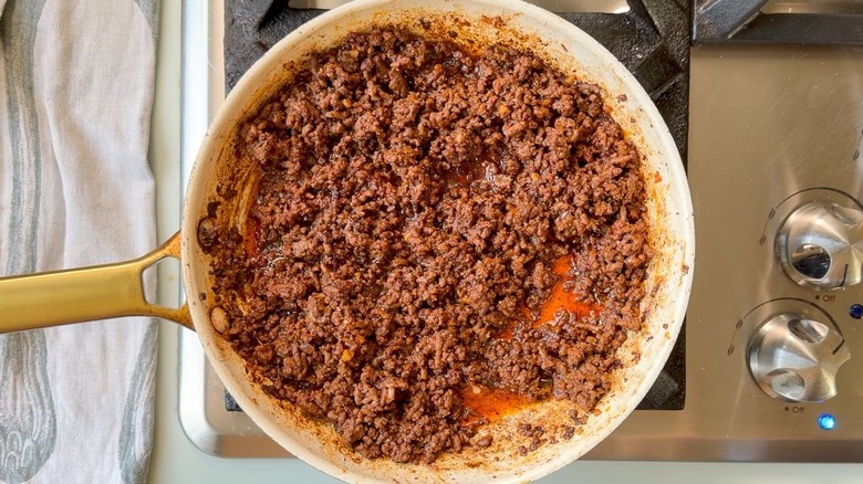 Ras el hanout beef cooking in skillet with beef bone broth