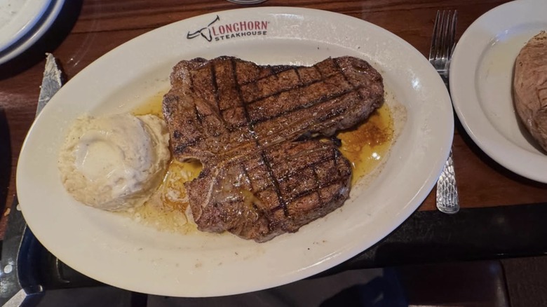 Steak on Longhorn Steakhouse-branded plate