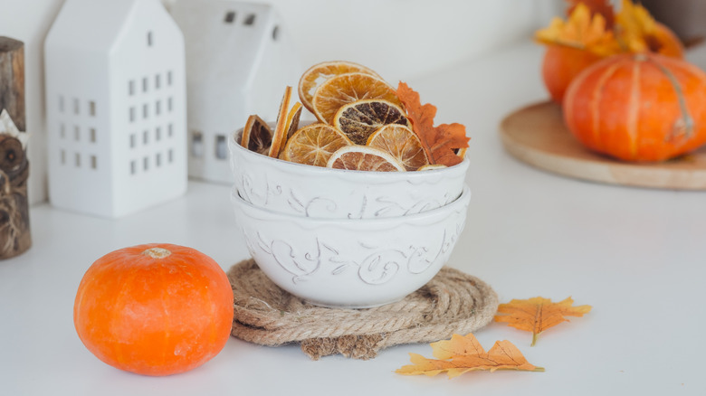 Dried oranges and pumpkin used as decoration on a white table