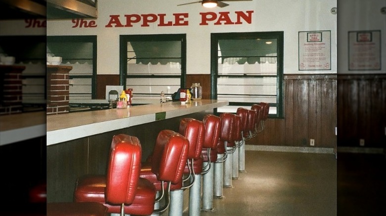 The counter at The Apple Pan lined with red cushy stools.