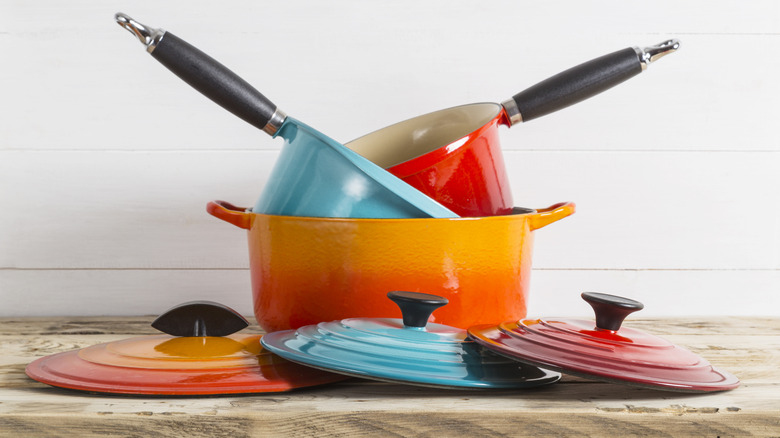 A stack of enameled cast-iron pots and pans