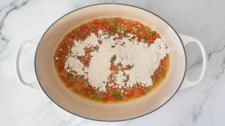 chopped cooked vegetables in a pot with flour