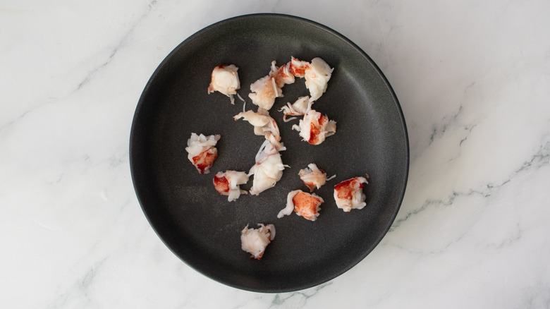lobster meat in a black bowl