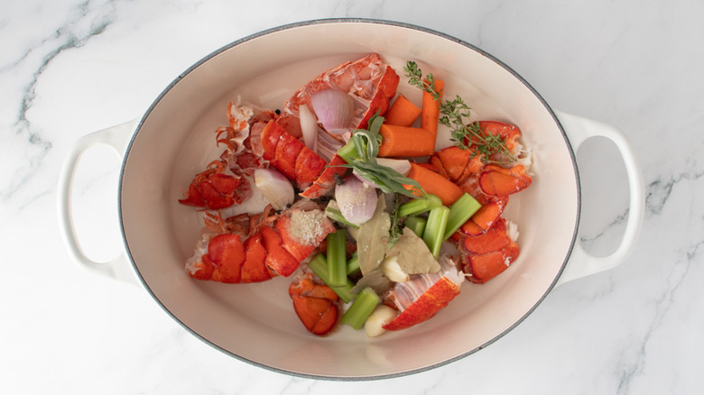 vegetables and lobster shells in a pot
