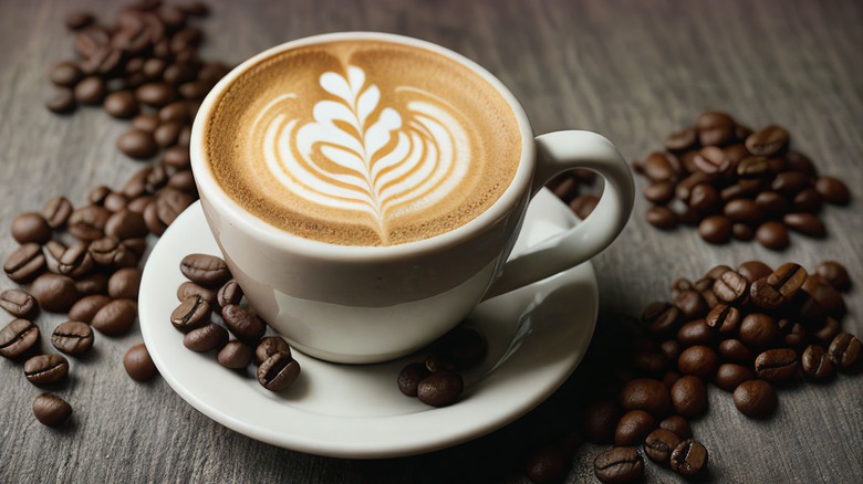 a cup of coffee surrounded by espresso beans