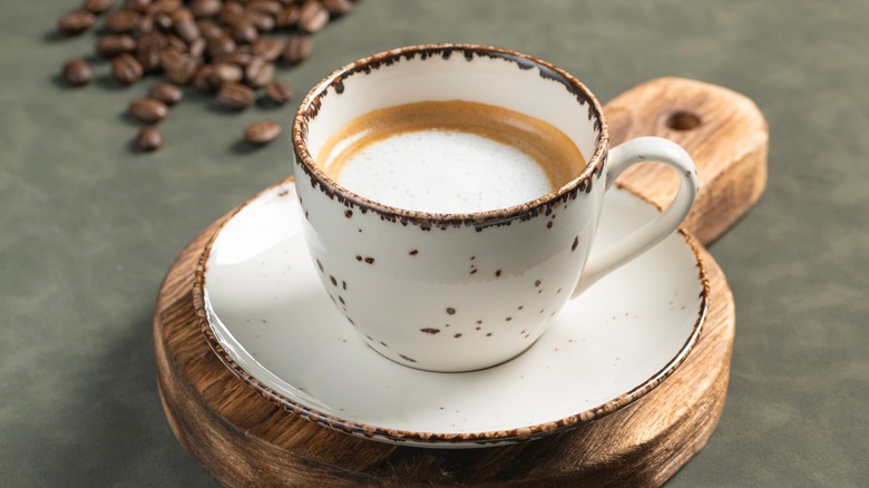 Traditional macchiato in a coffee mug with saucer