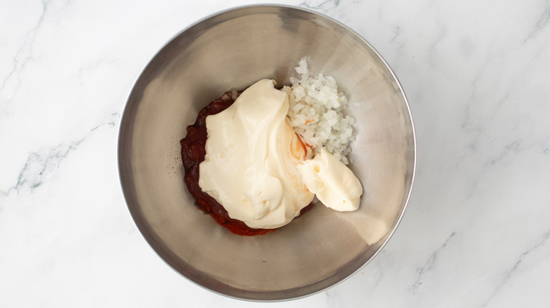 aerial view of dressing ingredients in bowl on marble surface