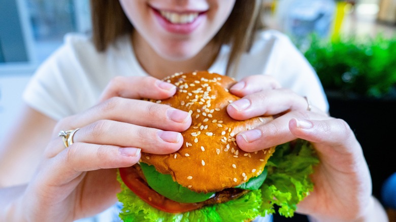 happy person eating a burger