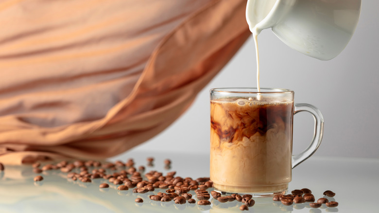milk in coffee with beans