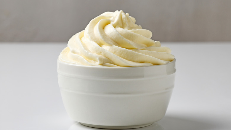 Bowl of whipped cream on a white kitchen counter.