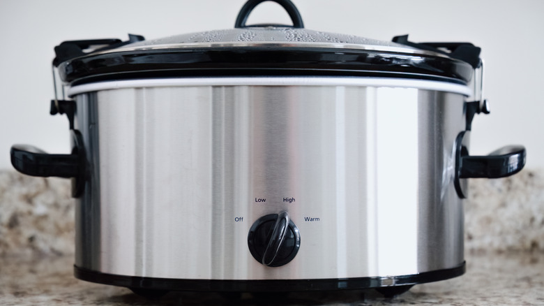 Silver crockpot on a gray granite counter