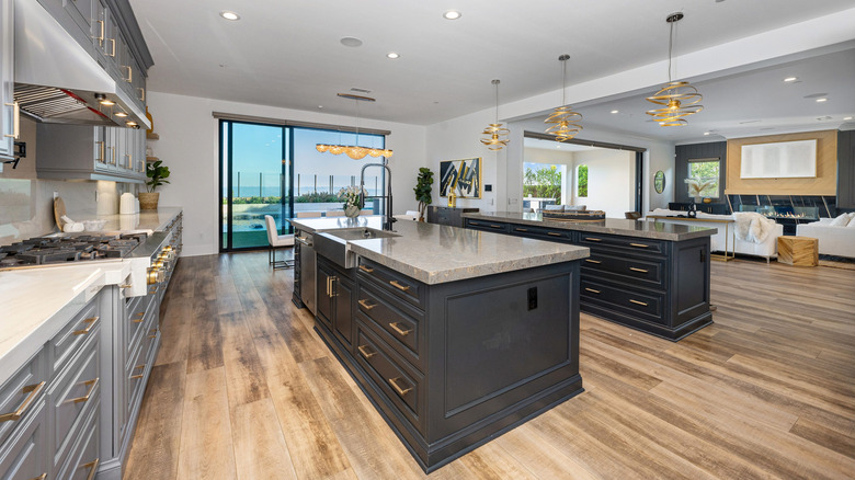 A nice kitchen has a double island and light blue range.