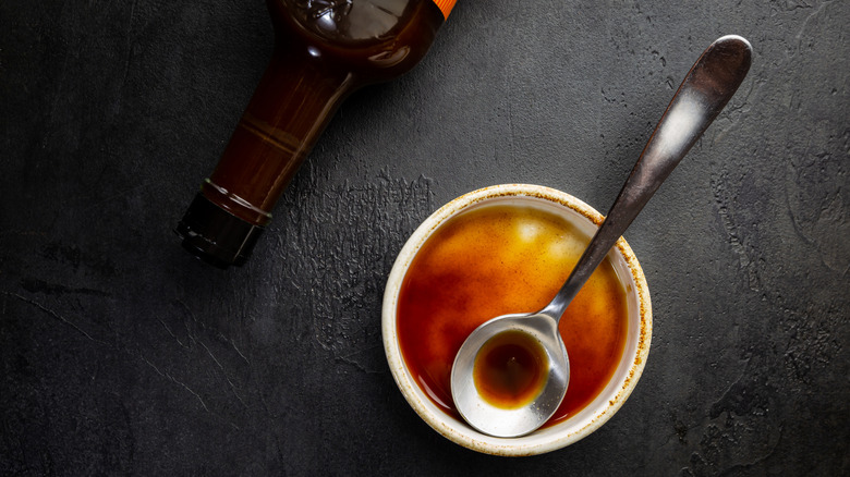 Worcestershire sauce in a bowl with a spoon.