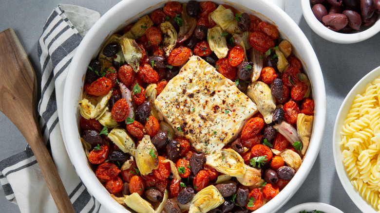 Baked feta with olives, artichokes, tomatoes
