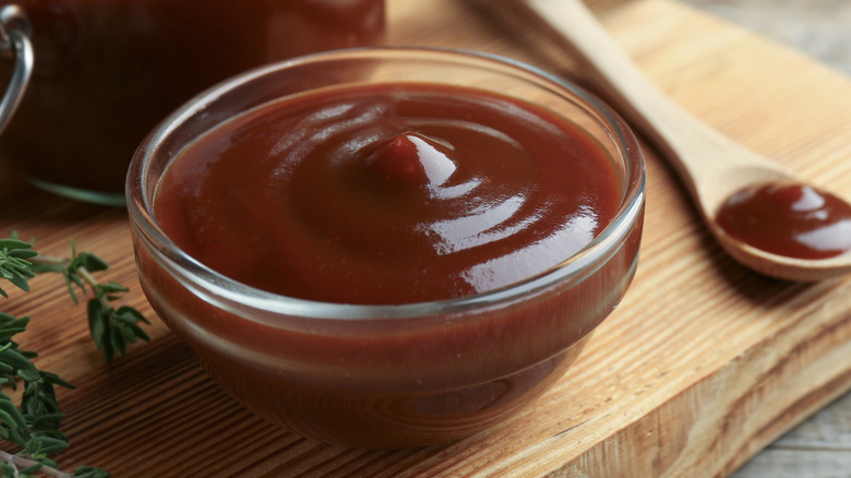 homemade barbecue sauce in a glass bowl with a spoon