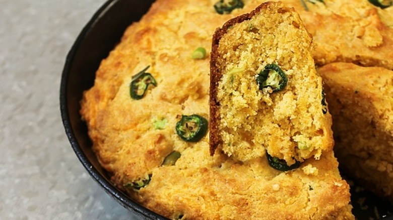 A closeup of cornbread with jalapeño slices