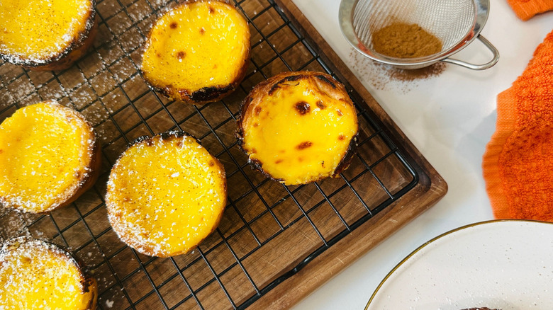 Portuguese custard tarts on wire rack