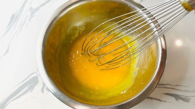 Egg yolks and whisk in bowl