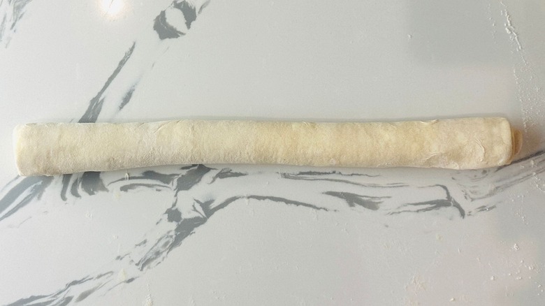 Pastry dough log on countertop