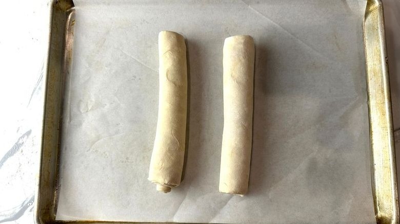 Two dough logs on baking sheet