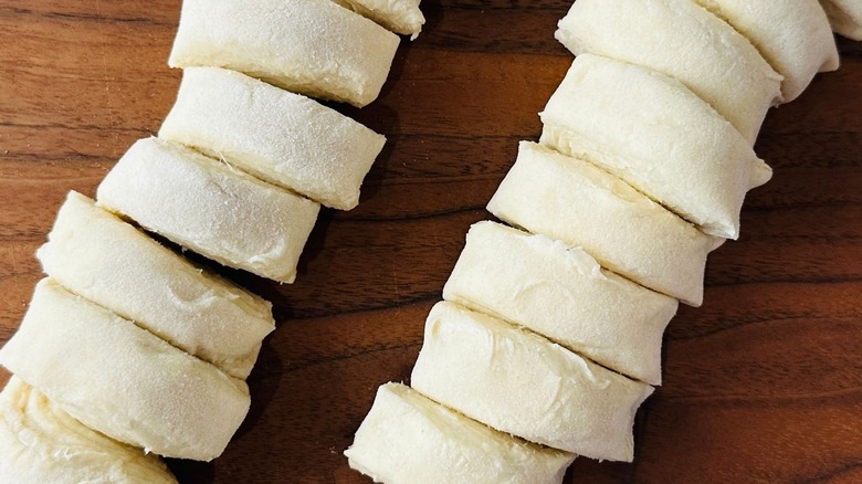 Slices of pastry dough on cutting board