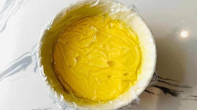 Custard in bowl covered with plastic