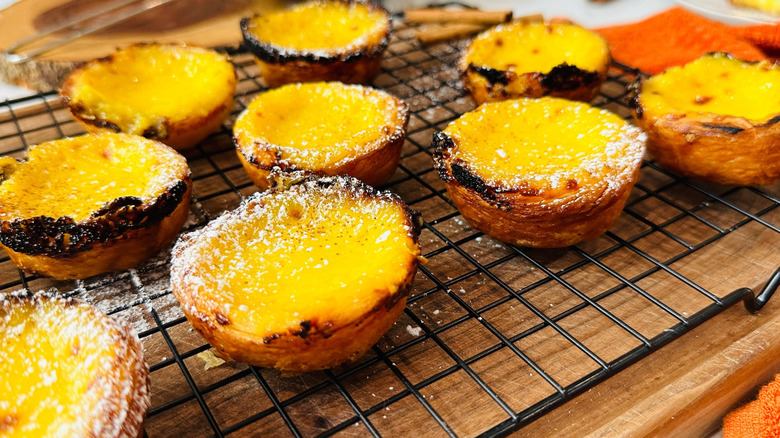 Portuguese custard tarts on wire rack
