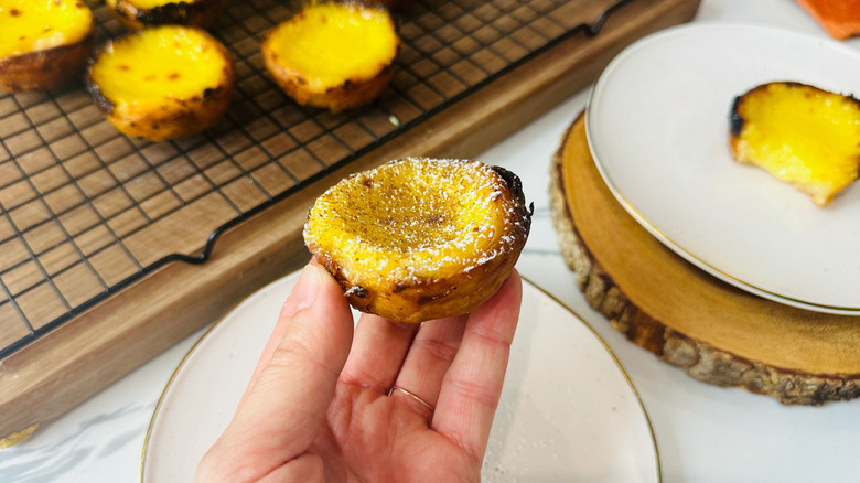 Hand holding Portuguese custard tart
