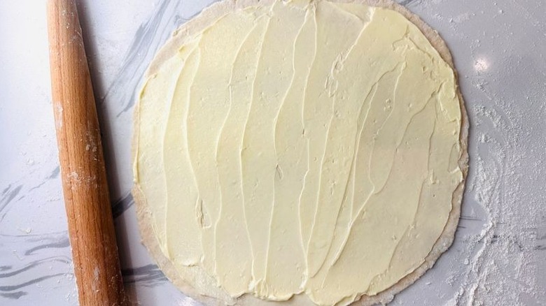 Dough rolled out and coated in butter