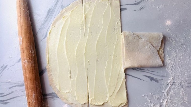 Butter coated pastry dough with portion folded over