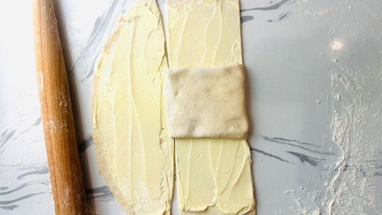 Butter coated pastry dough with portion folded over