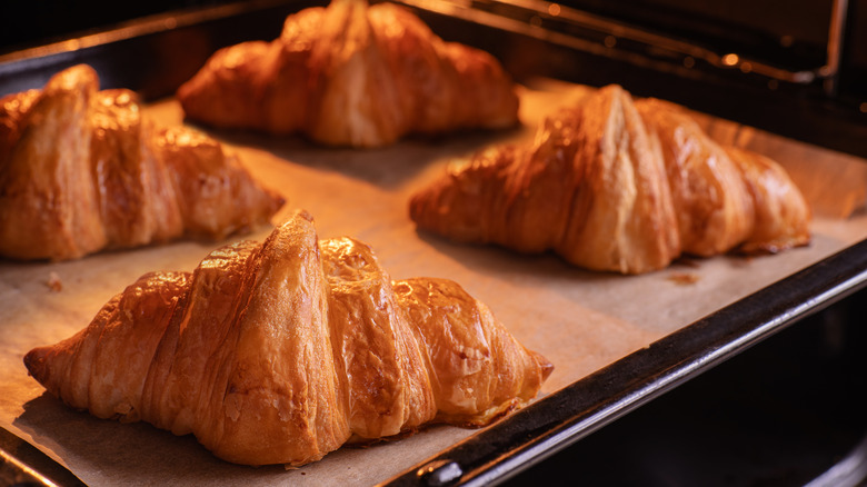 Croissants on a baking sheet in the oven