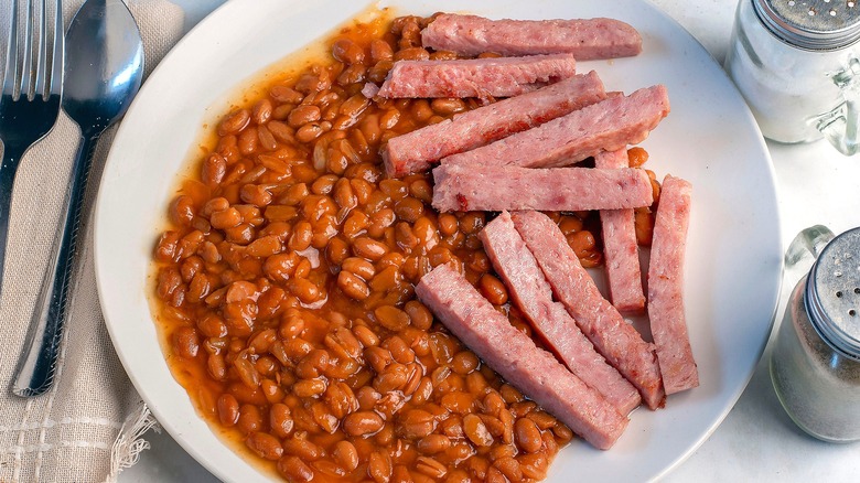 White plate full of baked beans and Spam fries