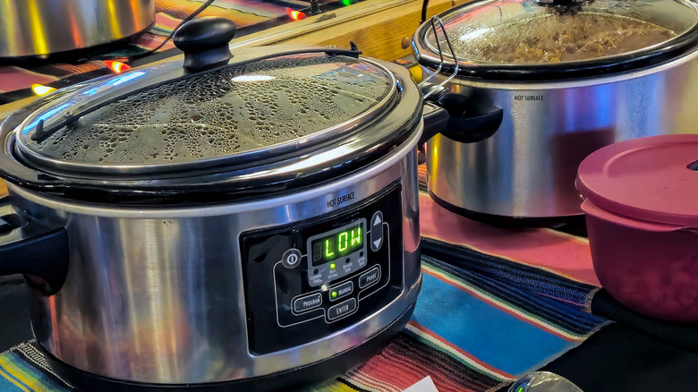 crock pots lined up on a table