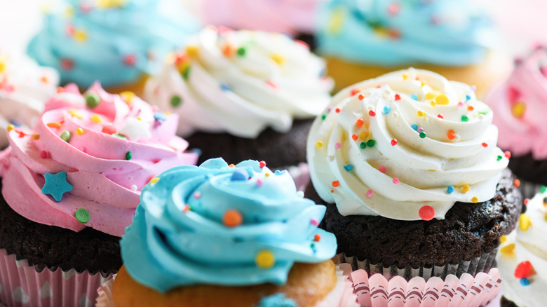 close-up of chocolate cupcakes with colorful frosting