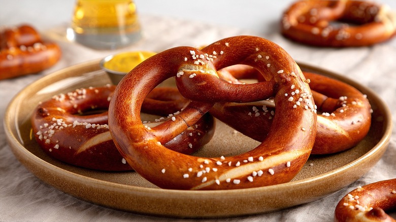 Soft pretzels with coarse salt on a ceramic plate