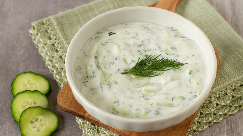 bowl full of tzatziki sauce garnished with dill