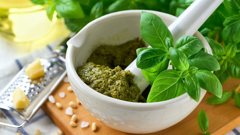 A white bowl full of pesto.